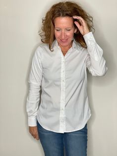 Our perfect fit cotton stretch button down. The Shirt reimagined for the perfect fit – powered by No Gape® button technology. Bye bye blouse gape, Hello The Shirt. Patented and designed by Rochelle Behrens to eliminate blouse gape. 75% Cotton, 20% Nylon, 5% Spandex Made in Portugal Powered by No Gape® button technology The Essentials Shirt runs a bit tailored at the waist, chest and back. For a contemporary fit, order true size. For a blousier fit, size up. S - Sleeve length 24, length 26.5M - S Classic Fitted Blouse For Everyday, Classic Fitted Everyday Shirt, Essentials Shirt, Service Women, Bye Bye, Ladies Boutique, Looks Great, Button Downs, Perfect Fit