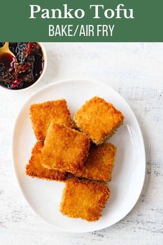 fried panko tofu on a white plate with dipping sauce in the background and text overlay that reads, how to make panko tofu bake / air fry