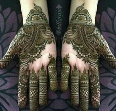 two hands with henna designs on them