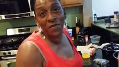 a woman standing in a kitchen next to an oven