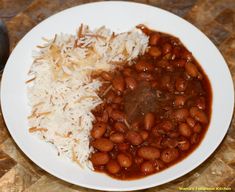 a white plate topped with rice and beans