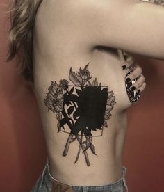 a woman with a sunflower tattoo on her back and shoulder, holding a knife