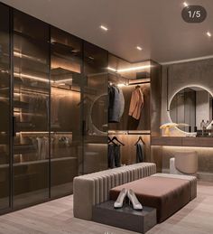 a walk in closet with clothes and shoes on the floor, next to a mirror