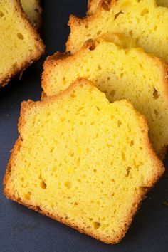 slices of yellow cake sitting on top of a table