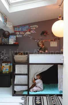 a woman sitting on top of a bunk bed next to a child in a room