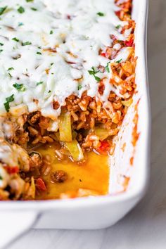 a casserole dish with meat, cheese and vegetables