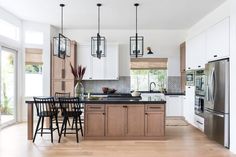 a kitchen with white cabinets and wooden floors