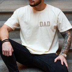 This dad shirt makes a totally unique gift for father's day celebrating new dads, old dads, and dads to be. Grab this tee today while it's on sale! Delivery Times: ◦ Production: 1 business day (avg.)  ◦ Shipping: 3 business days (avg.) Overview: ◦ Comfort Colors® branded retro t-shirt with muted vintage-style colors & a relaxed fit ◦ Pre-shrunk, ethically-sourced, 100% ring-spun American cotton ◦ Relaxed fit with the option to size up for an"oversized" or "shirt-dress" look ◦ Multiple retro, sof Cotton T-shirt For Father's Day, Family Matching Relaxed Fit T-shirt For Father's Day, Father's Day Family Cotton T-shirt, Father's Day Relaxed Cotton T-shirt, Personalized T-shirt For Father's Day, Father's Day Gift T-shirt With Relaxed Fit, Father's Day Gift Casual T-shirt, Casual Tops For Father's Day Gift, Custom Text T-shirt For Family On Father's Day