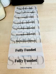 three numbered labels on a wooden table that say fully funded