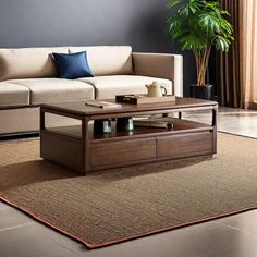 a living room with a couch, coffee table and potted plant on the floor