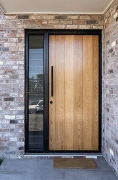 a wooden door is on the side of a brick building