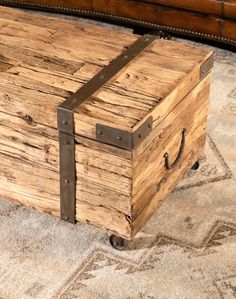 an old wooden trunk sitting on top of a rug