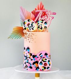 a multi - colored cake decorated with animal print and decorations