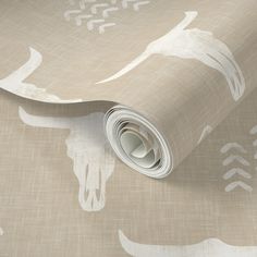 a wallpaper with an animal pattern on it's side and a roll of paper next to it