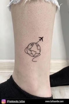 a woman's foot with a small world map tattoo on the side of her leg