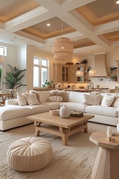 a living room filled with white furniture and lots of pillows on top of it's couches