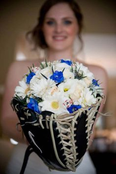 a woman holding a bouquet of white and blue flowers