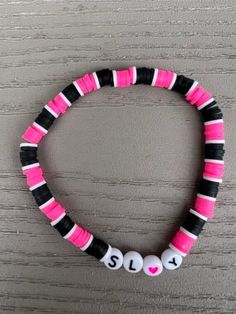 Clay beaded bracelet with SLAY spelled with beads. Bracelet is pink, black, and white on elastic rubber string. Clay Bead Bracelet Ideas Grunge, Trendy Pink Beaded Bracelets With Letter Print, Trendy Pink Bracelets With Letter Print, Casual Pink Bracelet With Letter Print, Trendy Pink Letter Print Bracelets, Trendy Black Wristband With Letter Beads, Clay Bead Bracelet Pink, Clay Bead Bracelets Ideas, Bracelets Preppy