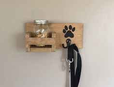 there is a dog paw on the wall with a leash hanging from it's hook