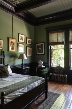 a bedroom with green walls and pictures on the wall