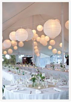 the tables are set with white paper lanterns