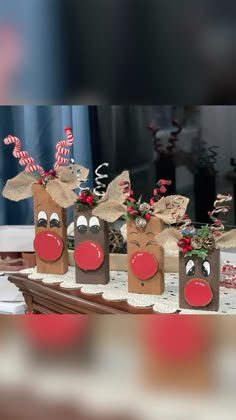 some brown bags with red noses and nose decorations on top of a wooden table in front of a window