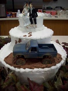 a wedding cake made to look like a truck and bride and groom on the top tier