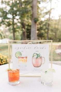 a table with drinks and a sign on it