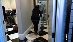 a pregnant woman is walking down the hallway