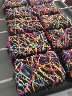 chocolate covered donuts with sprinkles on a tray