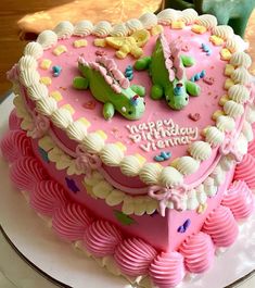 a heart shaped birthday cake on a plate