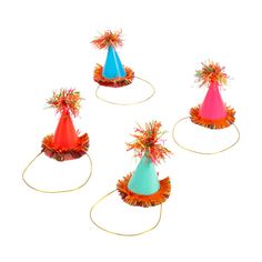 four party hats with streamers and ribbons on them are arranged in the shape of an upside down cone