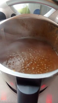 a pot filled with liquid sitting on top of a stove