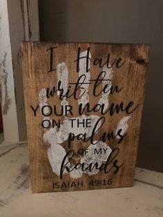 a wooden sign that says i have written on your name on the palms of my hands