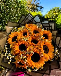 a bouquet of sunflowers and baby's breath are arranged on top of each other