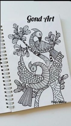 a spiral notebook with an image of two birds on it and the words, gond art