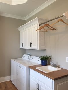 a white washer and dryer sitting in a laundry room next to a sink