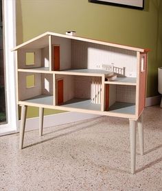 the doll house is made out of wood and has multiple sections to fit in it