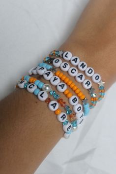 the bracelets are decorated with letters and beads