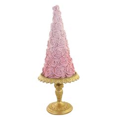 a pink and gold colored table lamp with roses on the base, sitting on a white background