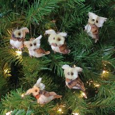 small stuffed animals are hanging from the branches of a christmas tree