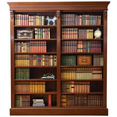 an old wooden bookcase with many books on it