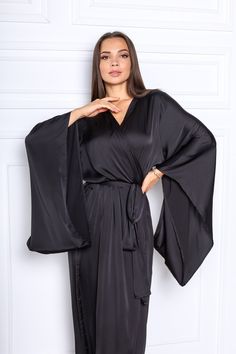 "This black silk satin robe is a kimono style robe with long wide sleeves. The robe is made of silk satin (Polyester -70%, viscosa-30%). The size of the robe on the photo is M (length is 142 cm / 56\"\"). The size and color can be chosen in the variations. What would you prefer elegance or comfort? It's probably hard to choose as even at home you want to look great and can relax after the busy day! That is why it's important to choose the right clothes. No matter if you are relaxing at home alon Silk Robe Kimono, Bridal Kimono Robe, Long Silk Robe, Black Silk Robe, Black Satin Robe, Long Bridal Robe, Silk Bridal Robe, Silk Bridesmaid Robes, Silk Robe Long