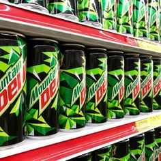 many cans of mountain dew on display in a store