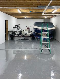 a garage with two boats and a ladder