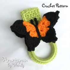 a crocheted hair band with a black and orange butterfly on it