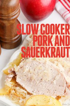 slow cooker pork and sauerkraut on a white plate with apples in the background