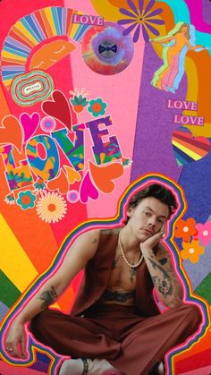 a man with tattoos sitting on top of a rainbow colored background and holding his hand to his face