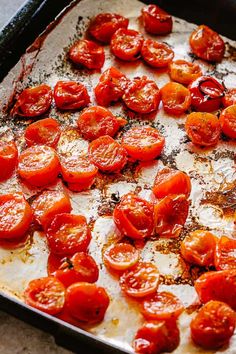 a pan filled with cooked tomatoes on top of a table