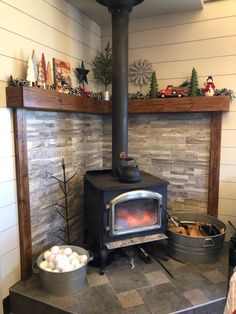 a wood burning stove sitting inside of a living room